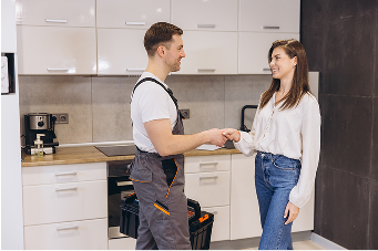 Two peopl shaking hands in kitchen
